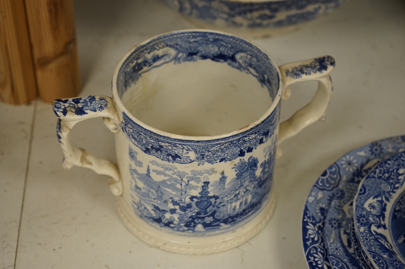 A group of blue and white ceramics to include Ironstone cheese dome and jug, a basin and twin handled cups, largest 36cm in diameter. Condition - varies